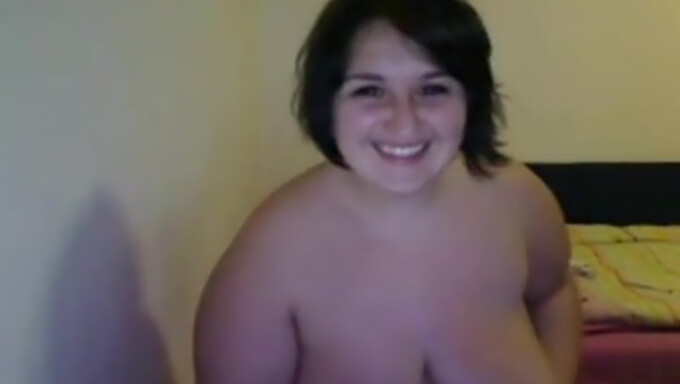 Chubby brunette flaunts her big natural tits in a live show